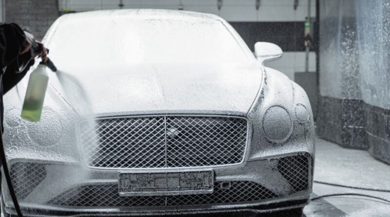 A luxury car is covered in foam during a detailed wash inside a garage. - Photo by Tima Miroshnichenko on Pexels