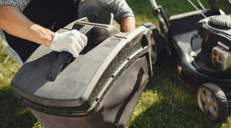 An adult man replacing a lawn mower bag on a sunny day in the yard. - Photo by Gustavo Fring on Pexels